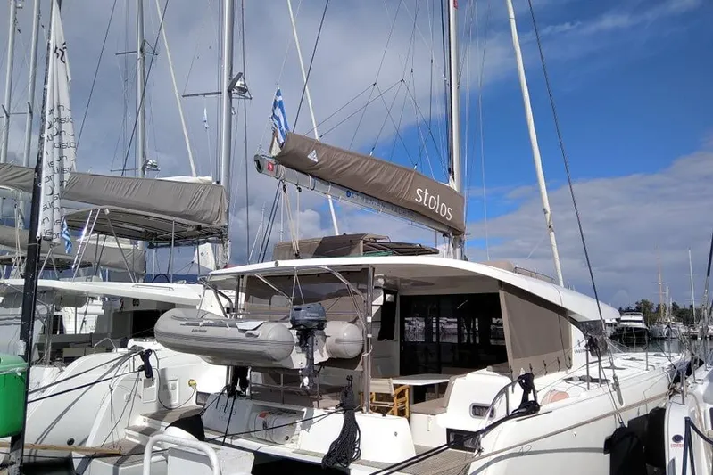 Stolos Yacht Photos Pics 2020 Lagoon 42 catamaran docked at marina under clear blue sky.