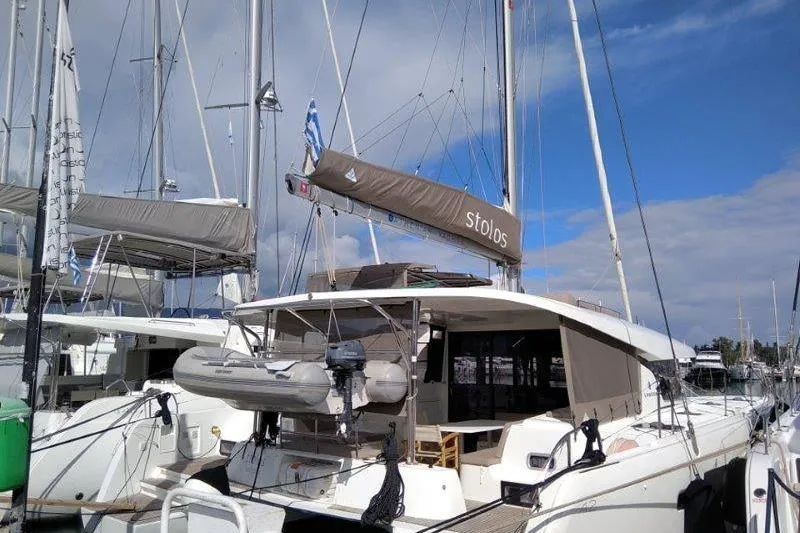 Stolos Yacht Photos Pics 2020 Lagoon 42 catamaran docked at marina under blue sky.