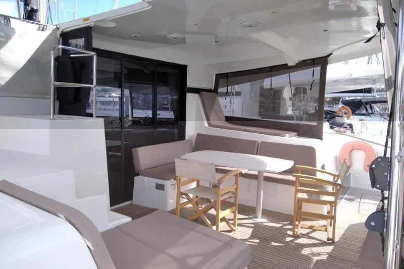 Stolos Yacht Photos Pics Spacious 2020 Lagoon 42 yacht deck with seating and table, featuring modern design.