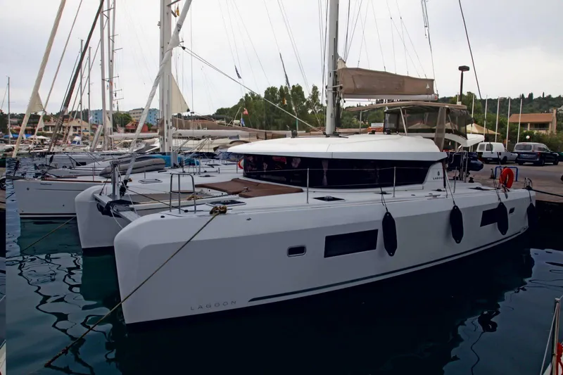 Stolos Yacht Photos Pics 2020 Lagoon 42 catamaran docked at marina, featuring sleek design and modern amenities.