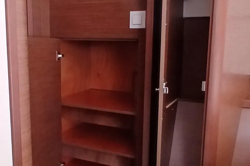 Stolos Yacht Photos Pics Wooden interior shelving in a 2020 Lagoon 42 yacht cabin.