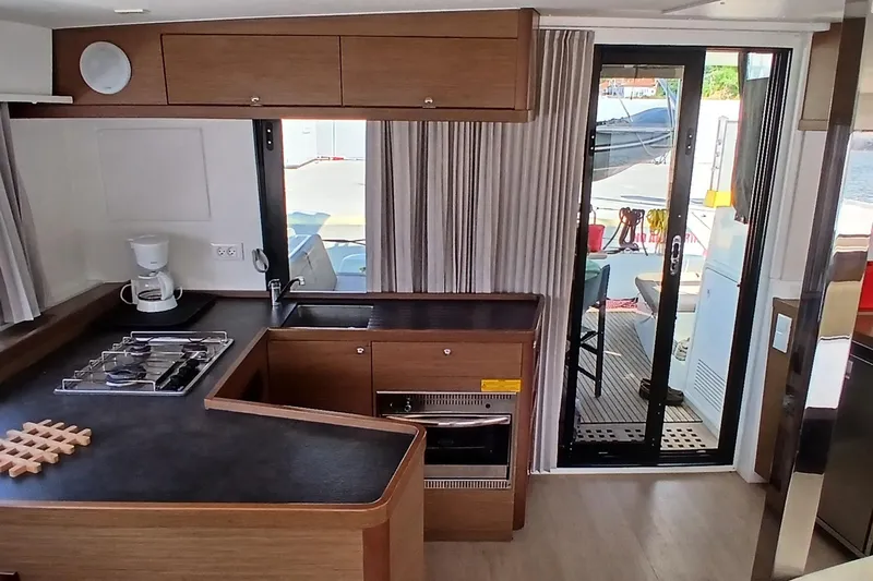 Stolos Yacht Photos Pics Interior of 2020 Lagoon 42 yacht featuring modern kitchen and sliding glass door.