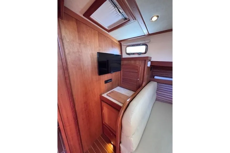 Independence Yacht Photos Pics Interior of 2012 Sabre 42 Salon Express with wood paneling and mounted TV.