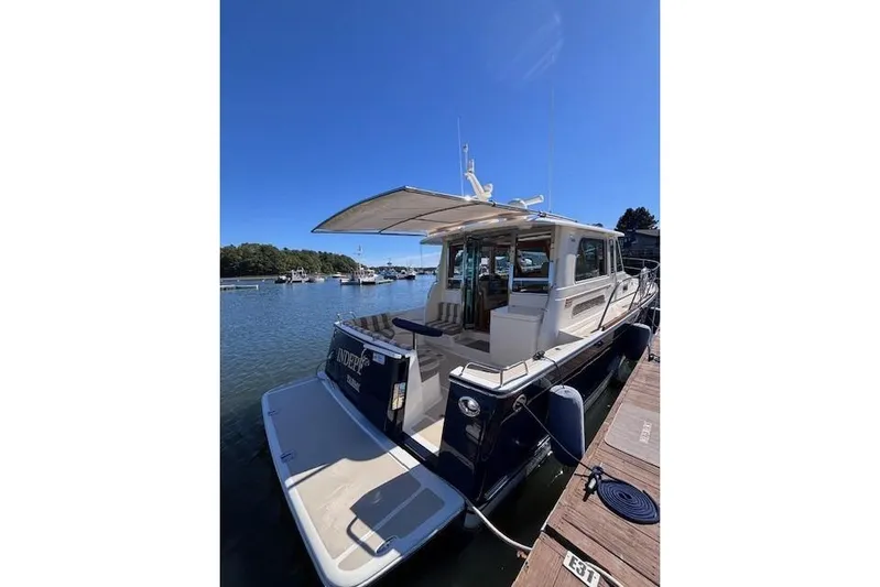 Independence Yacht Photos Pics 2012 Sabre 42 Salon Express yacht docked in a serene marina setting.