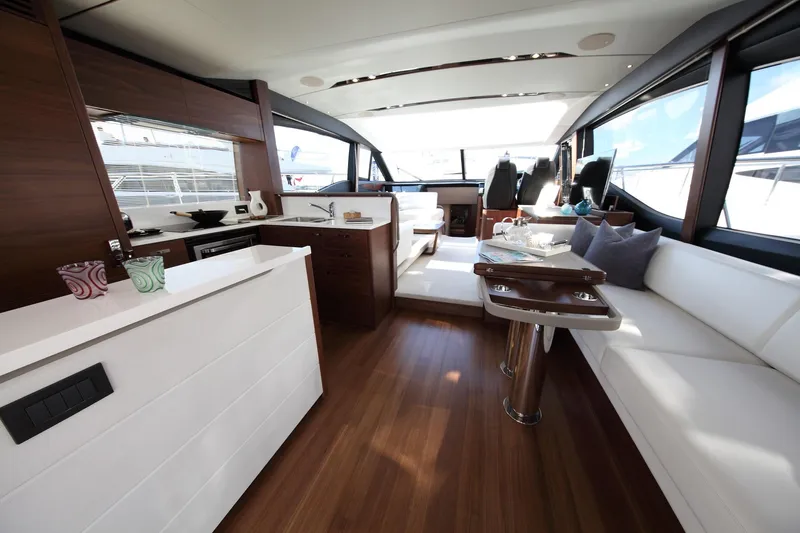  Yacht Photos Pics Luxurious interior of 2018 Princess S65 yacht with modern kitchen and seating area.