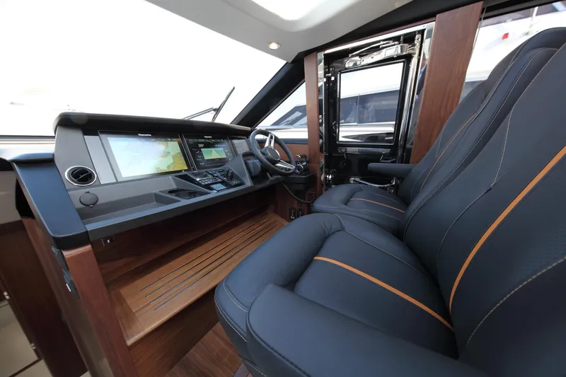  Yacht Photos Pics Luxurious 2018 Princess S65 yacht cockpit with leather seating and advanced navigation displays.