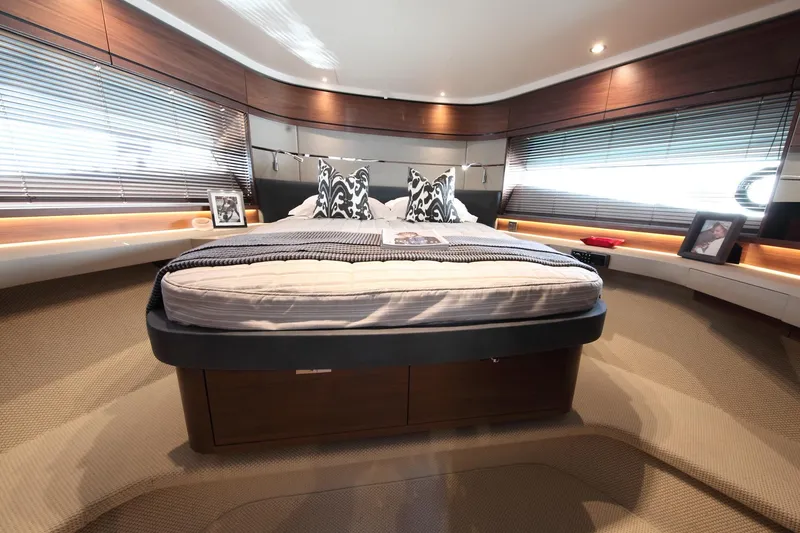  Yacht Photos Pics Luxurious bedroom interior of 2018 Princess S65 yacht with modern decor and ambient lighting.