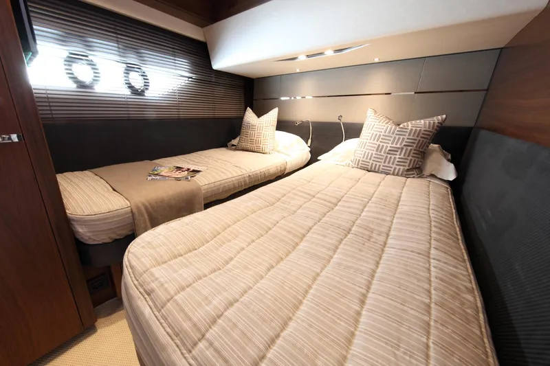  Yacht Photos Pics Luxurious twin cabin in 2018 Princess S65 yacht with modern decor and comfortable bedding.