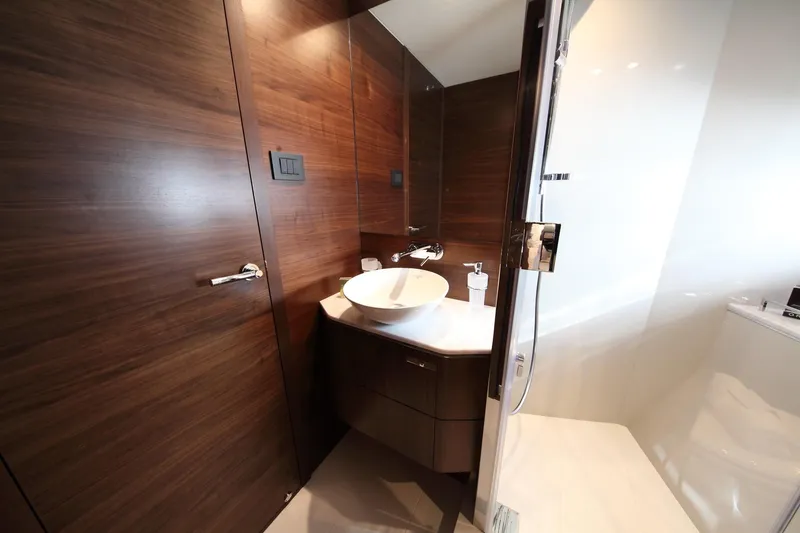  Yacht Photos Pics Luxurious 2018 Princess S65 yacht bathroom with modern wood paneling and sleek fixtures.