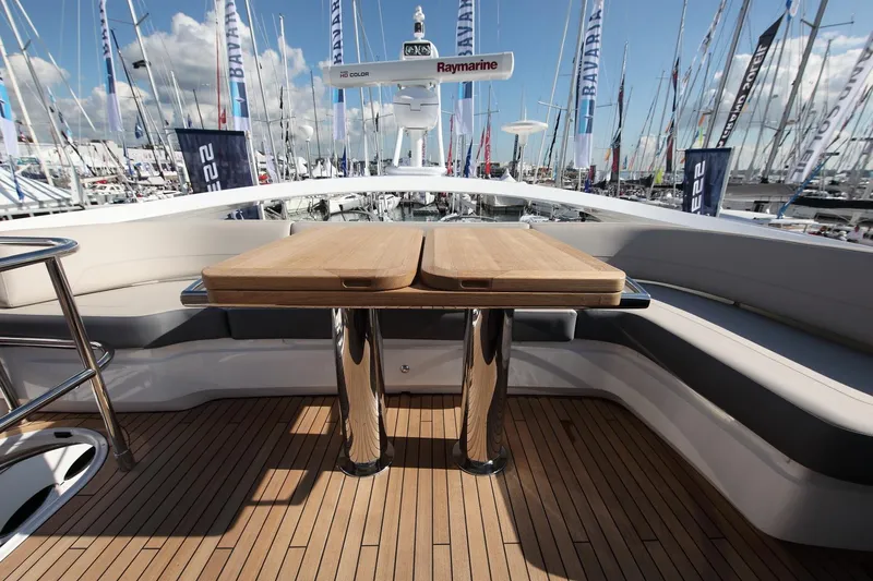  Yacht Photos Pics Luxurious 2018 Princess S65 yacht deck with wooden table and seating, surrounded by marina.