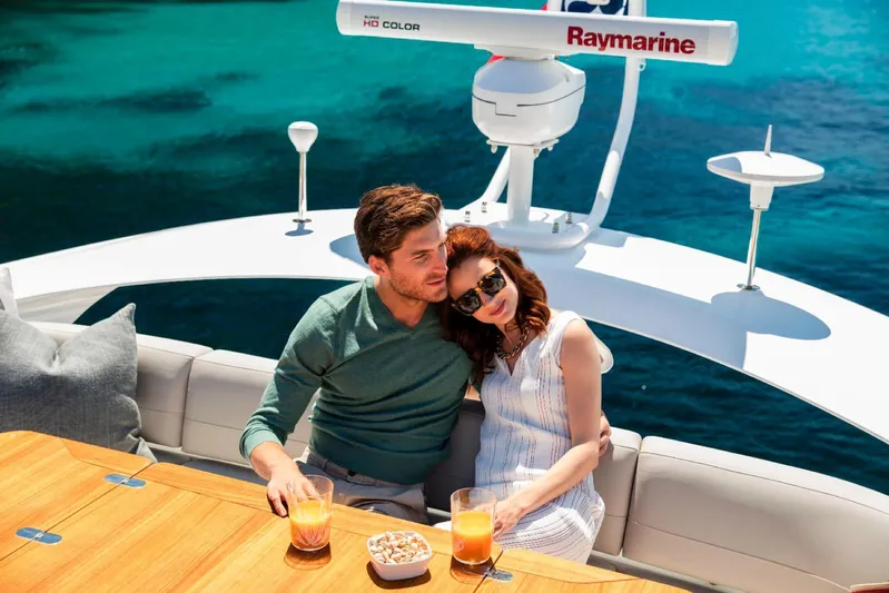  Yacht Photos Pics Couple relaxing on 2018 Princess S65 yacht with ocean view.