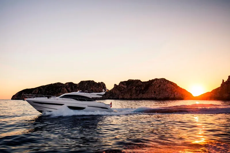  Yacht Photos Pics Luxury Princess S65 yacht cruising at sunset near rocky coastline, 2018 model.