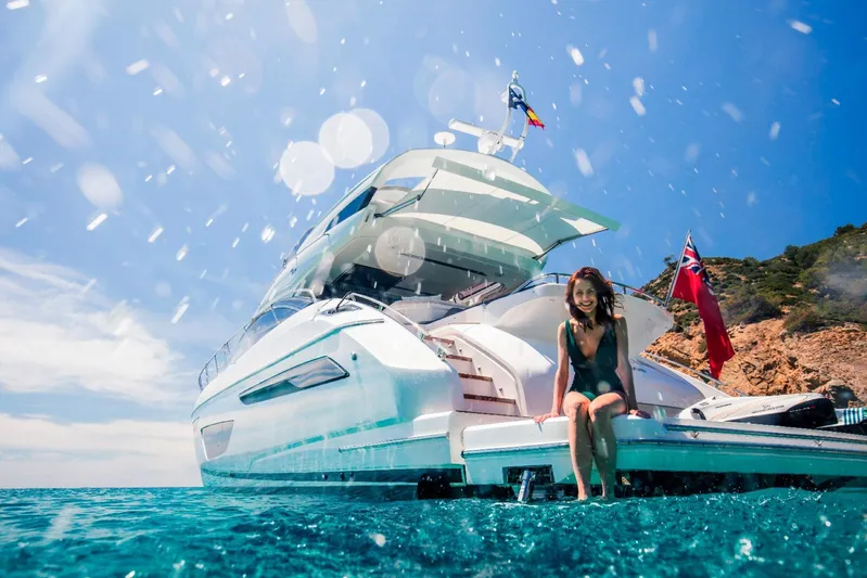  Yacht Photos Pics Woman enjoying sunny day on 2018 Princess S65 yacht, ocean backdrop.