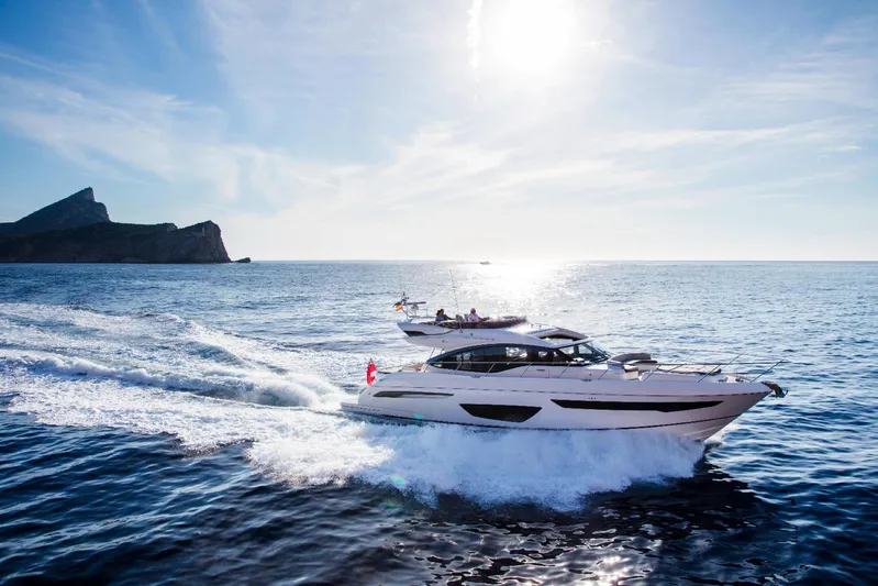  Yacht Photos Pics 2018 Princess S65 yacht cruising on open sea under clear blue sky.