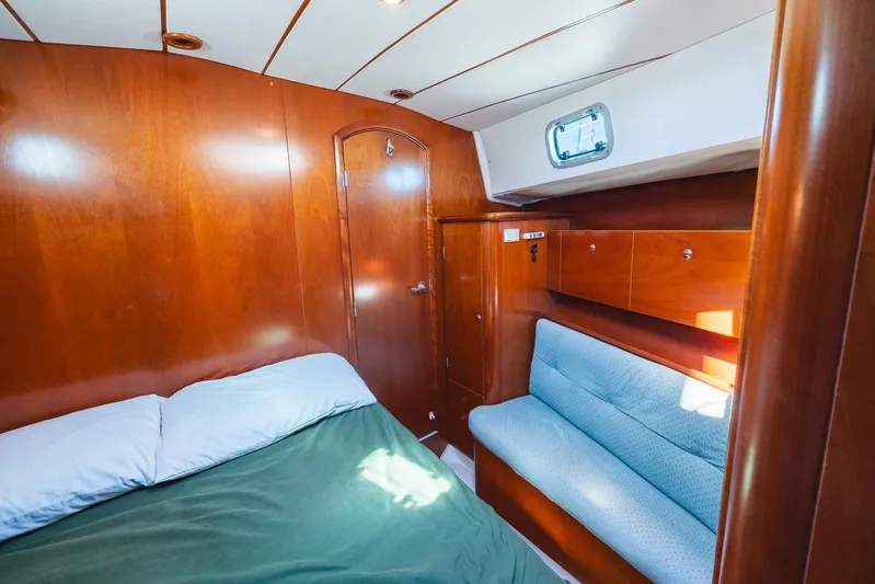  Yacht Photos Pics Cozy cabin interior of 2000 Beneteau Oceanis 40 CC sailboat with wood paneling and seating.