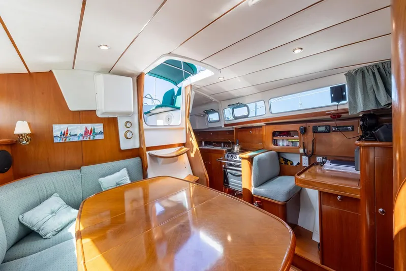  Yacht Photos Pics Interior of 2000 Beneteau Oceanis 40 CC yacht, featuring cozy seating and wooden finishes.