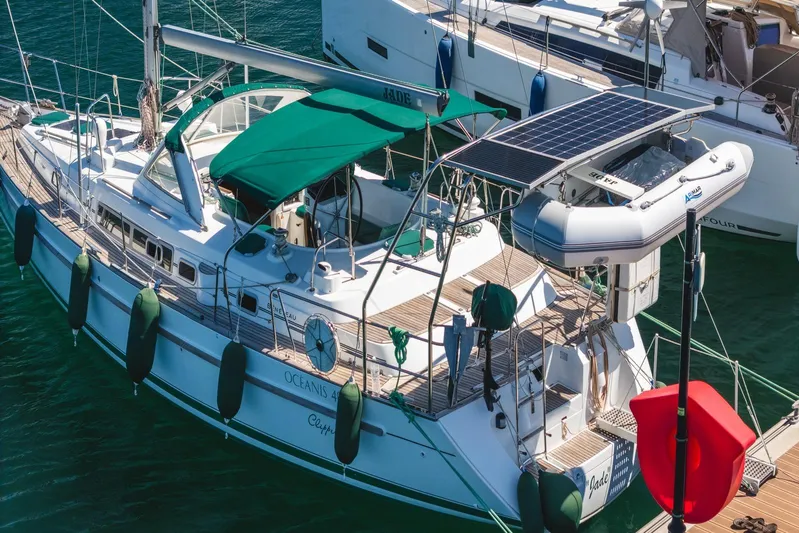  Yacht Photos Pics Beneteau Oceanis 40 CC sailboat, 2000 model, docked with green canopy and solar panels.