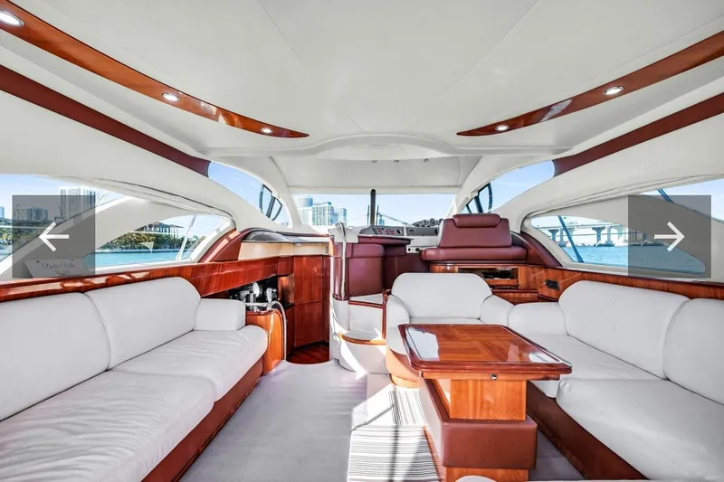  Yacht Photos Pics Luxurious interior of a 2006 Azimut Fly yacht with elegant wood and white seating.