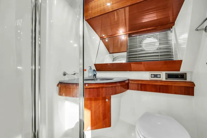  Yacht Photos Pics Luxurious 2006 Azimut Fly yacht bathroom with wood accents and modern fixtures.