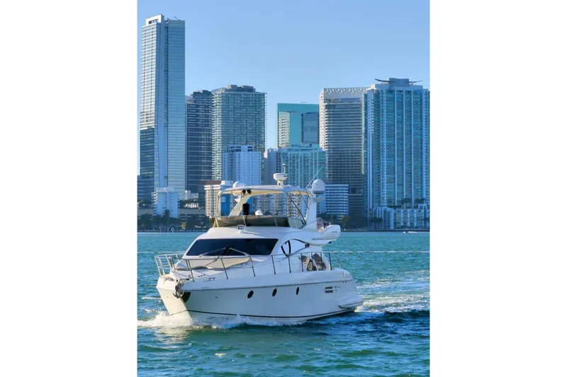  Yacht Photos Pics Azimut Fly 2006 yacht cruising near city skyline on a sunny day.