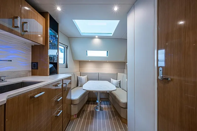  Yacht Photos Pics Luxurious interior of 2025 Formula 500 Super Sport Crossover with modern kitchen and seating area.