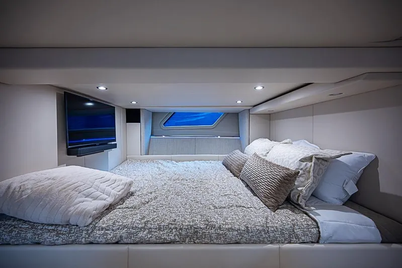  Yacht Photos Pics Luxurious cabin interior of 2025 Formula 500 Super Sport Crossover with cozy bedding and modern TV.