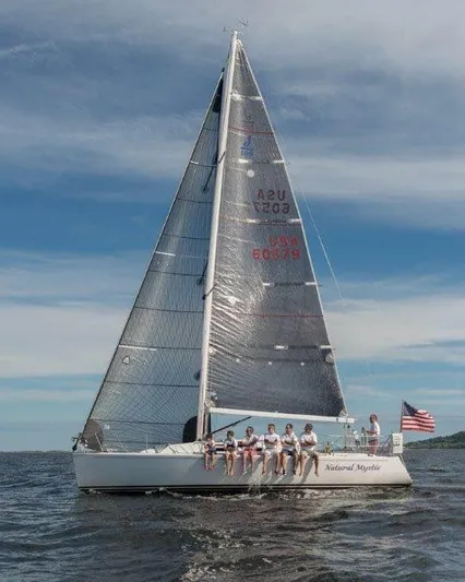Natural Mystic Yacht Photos Pics 2003 J Boats J/109 sailing with crew on a sunny day, American flag visible.
