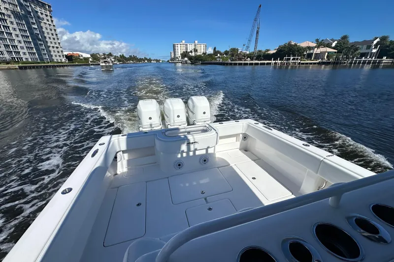  Yacht Photos Pics 2020 Invincible 39 Open Fisherman boat cruising on a sunny waterway.