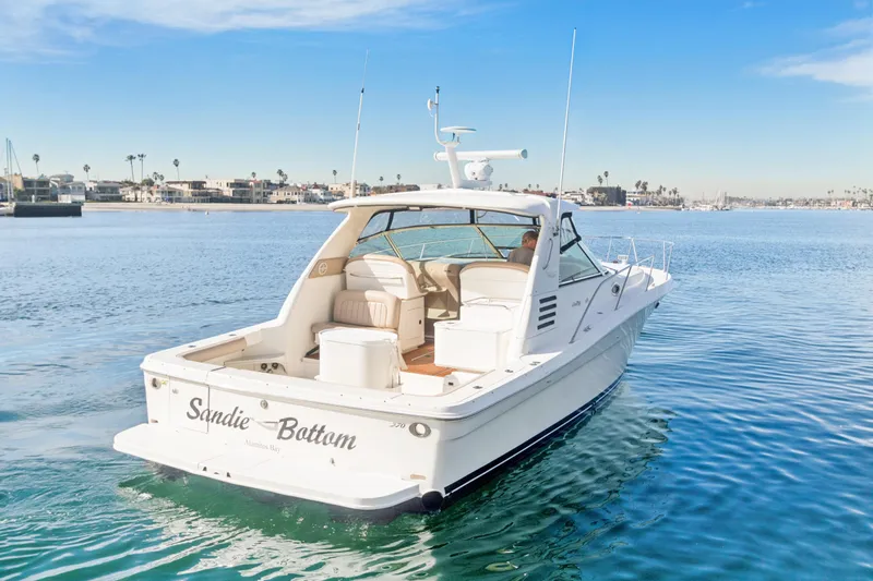 Sandie Lee Yacht Photos Pics 2000 Sea Ray 370 Express Cruiser on calm water, clear sky, coastal background.