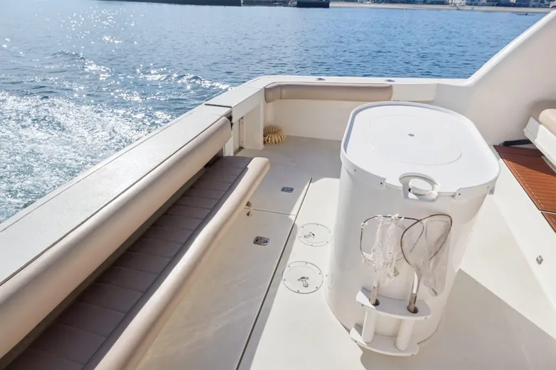 Sandie Lee Yacht Photos Pics 2000 Sea Ray 370 Express Cruiser deck with seating and fishing gear, cruising on open water.