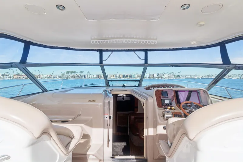 Sandie Lee Yacht Photos Pics Interior view of 2000 Sea Ray 370 Express Cruiser helm with ocean backdrop.