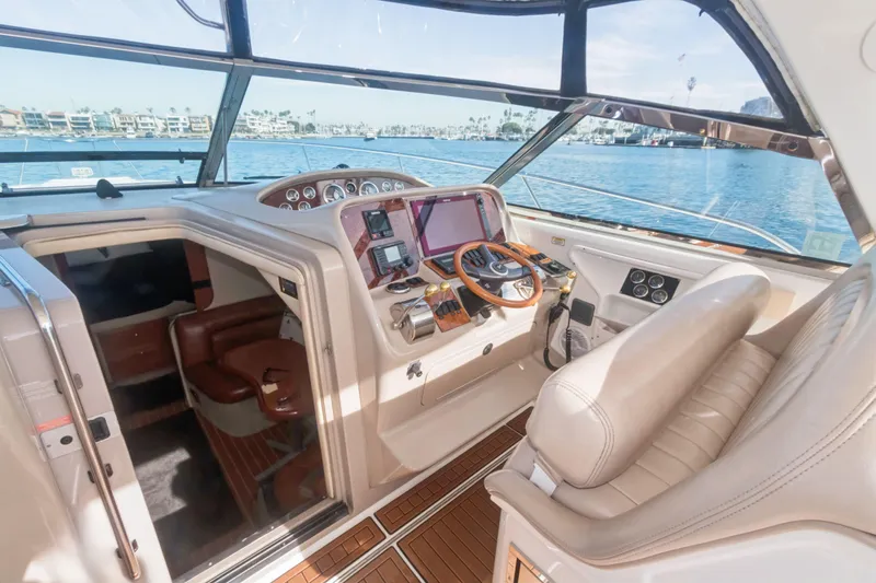 Sandie Lee Yacht Photos Pics Cockpit of 2000 Sea Ray 370 Express Cruiser with luxurious seating and navigation equipment.
