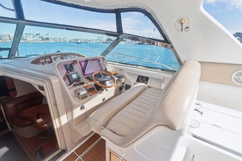 Sandie Lee Yacht Photos Pics Cockpit of 2000 Sea Ray 370 Express Cruiser with steering wheel and navigation equipment.