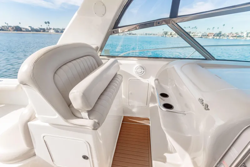 Sandie Lee Yacht Photos Pics 2000 Sea Ray 370 Express Cruiser interior with white seating and ocean view.