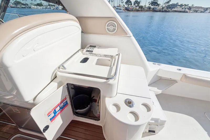Sandie Lee Yacht Photos Pics 2000 Sea Ray 370 Express Cruiser interior with open storage and cup holders by the water.