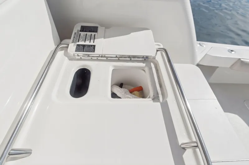 Sandie Lee Yacht Photos Pics 2000 Sea Ray 370 Express Cruiser deck storage compartment with cleaning supplies.
