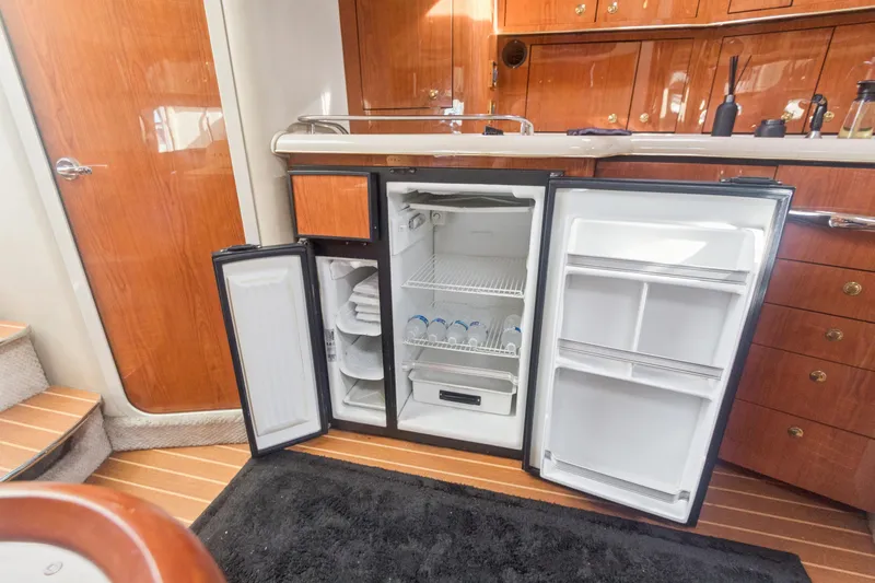 Sandie Lee Yacht Photos Pics Interior of 2000 Sea Ray 370 Express Cruiser with open refrigerator in kitchen area.