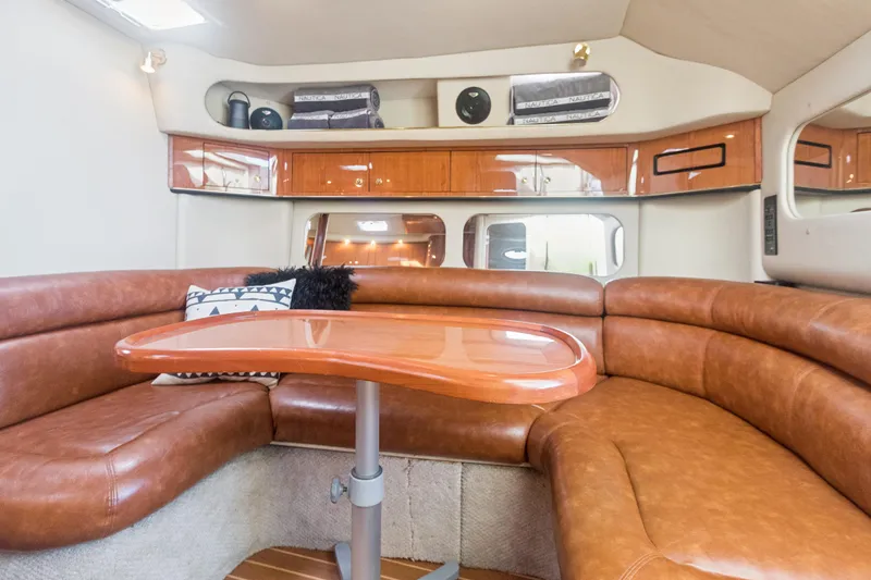 Sandie Lee Yacht Photos Pics Luxurious interior of 2000 Sea Ray 370 Express Cruiser with leather seating and wooden table.