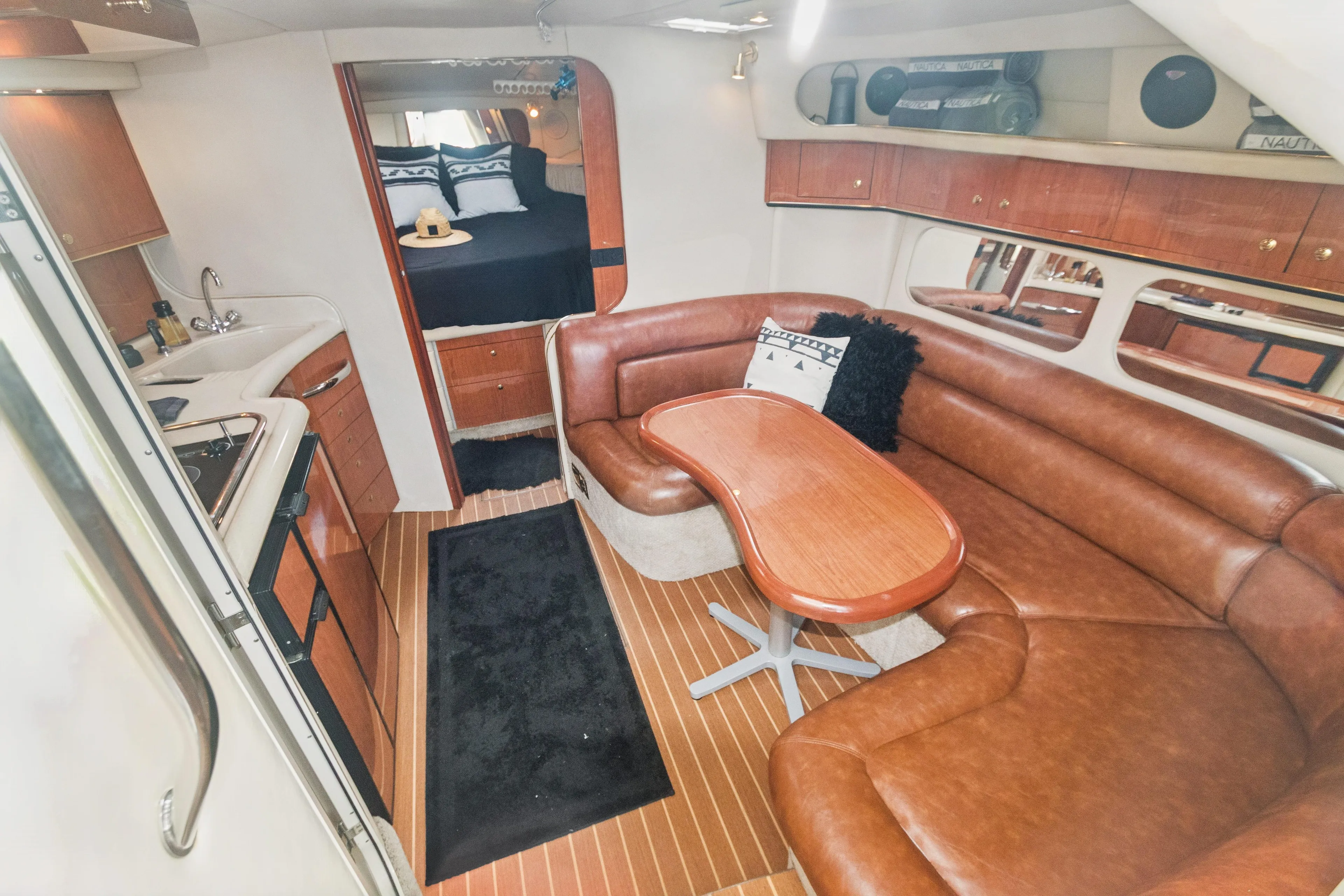 Luxurious interior of 2000 Sea Ray 370 Express Cruiser with leather seating and kitchenette.
