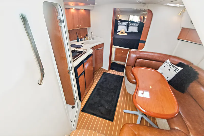 Sandie Lee Yacht Photos Pics Interior of 2000 Sea Ray 370 Express Cruiser with kitchen, seating, and bedroom.