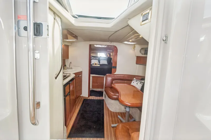 Sandie Lee Yacht Photos Pics Interior of 2000 Sea Ray 370 Express Cruiser with kitchen and seating area.