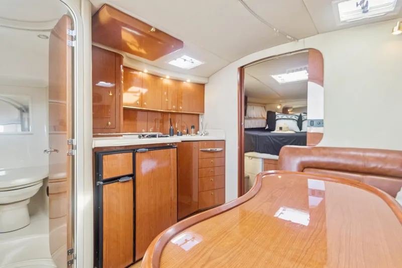 Sandie Lee Yacht Photos Pics Interior of 2000 Sea Ray 370 Express Cruiser with kitchen and seating area.