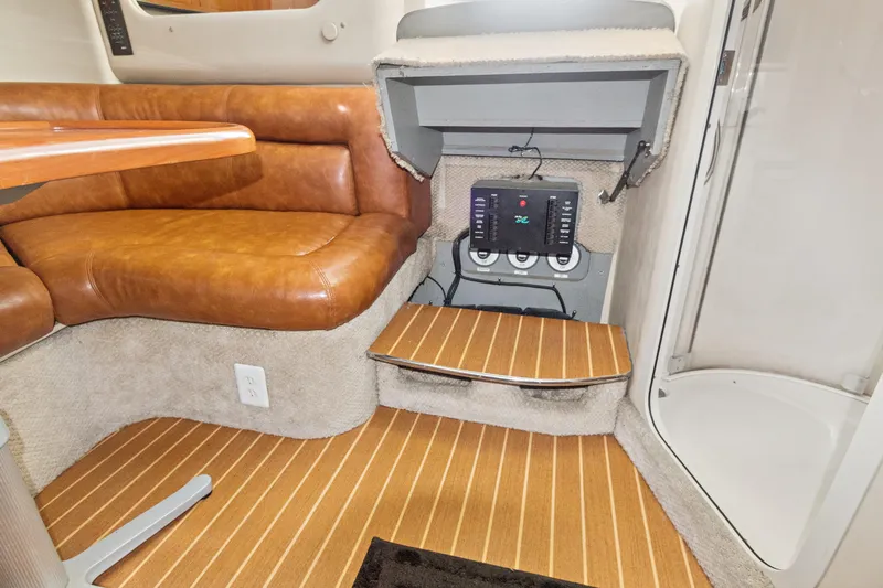 Sandie Lee Yacht Photos Pics 2000 Sea Ray 370 Express Cruiser interior with leather seating and control panel.