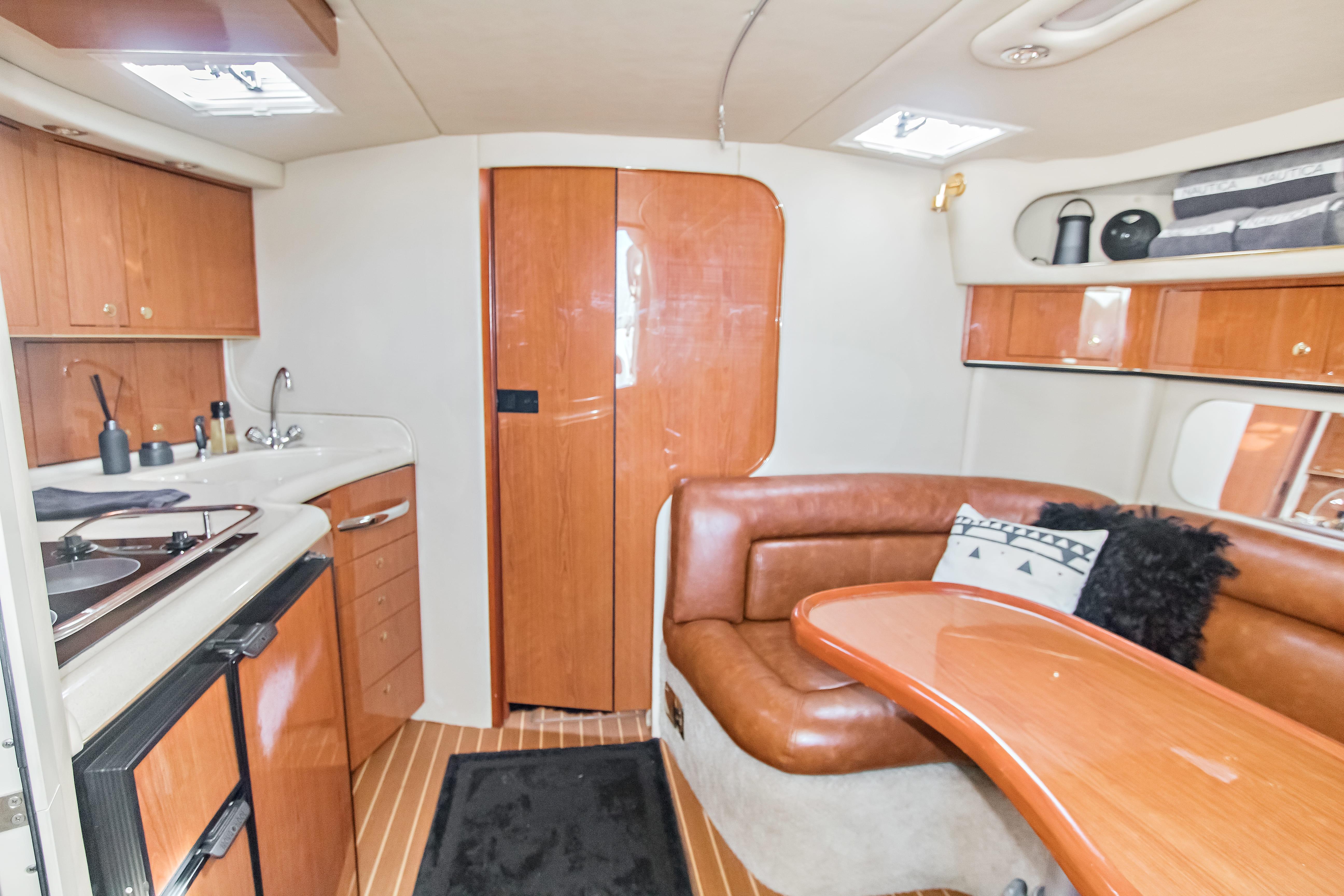 Interior of 2000 Sea Ray 370 Express Cruiser with kitchen and seating area.