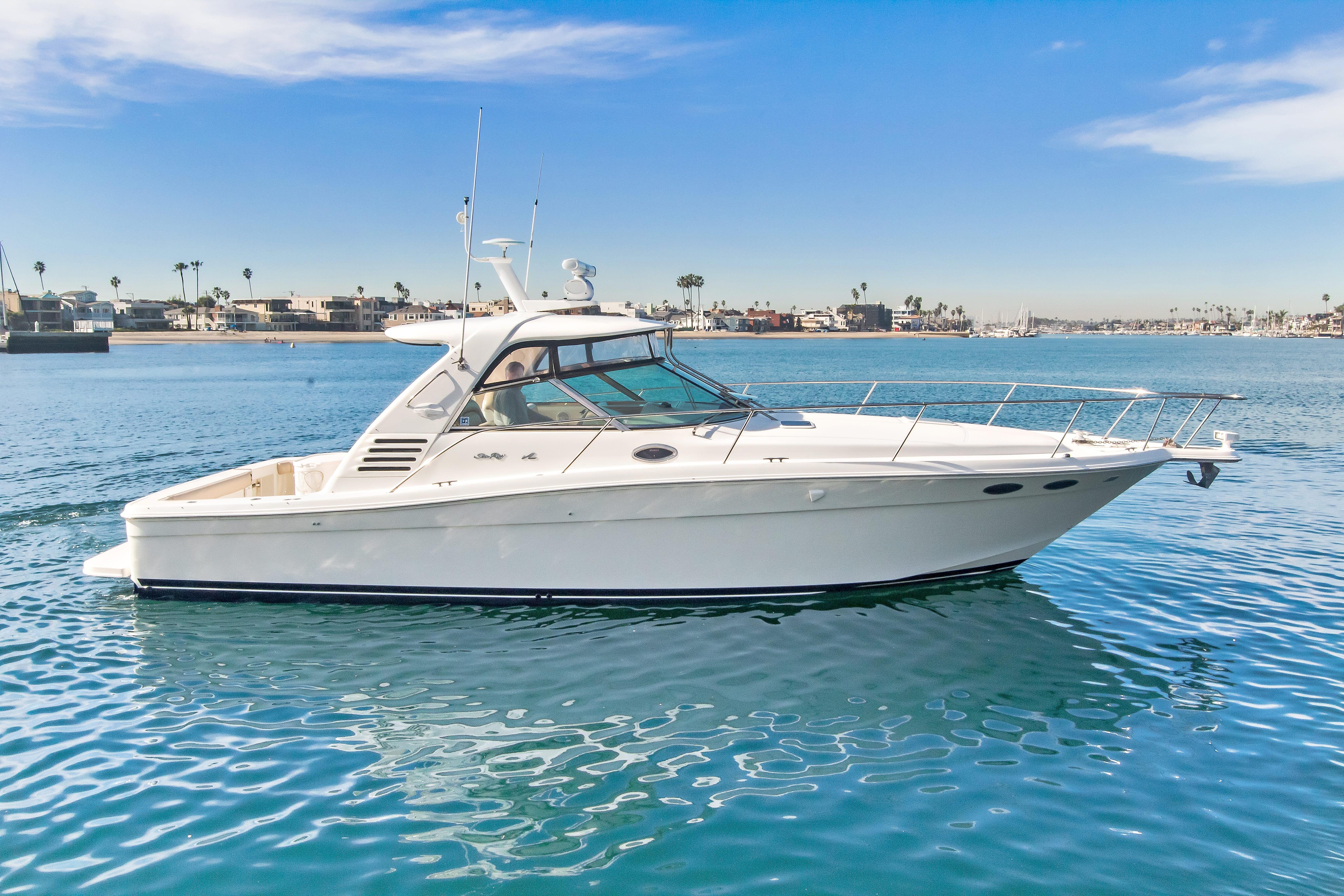 2000 Sea Ray 370 Express Cruiser on calm water, clear sky background.