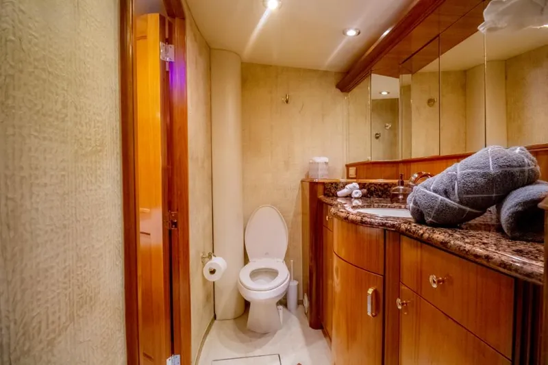 Reel Deal Yacht Photos Pics Luxurious bathroom in 2005 Sea Force Sportfish yacht with granite countertop and wooden cabinetry.