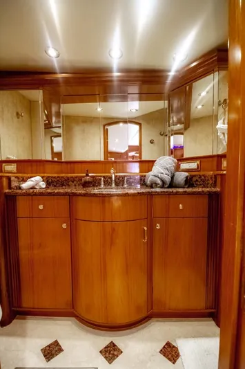 Reel Deal Yacht Photos Pics Luxurious bathroom in 2005 Sea Force Sportfish yacht with wooden cabinetry and granite countertop.