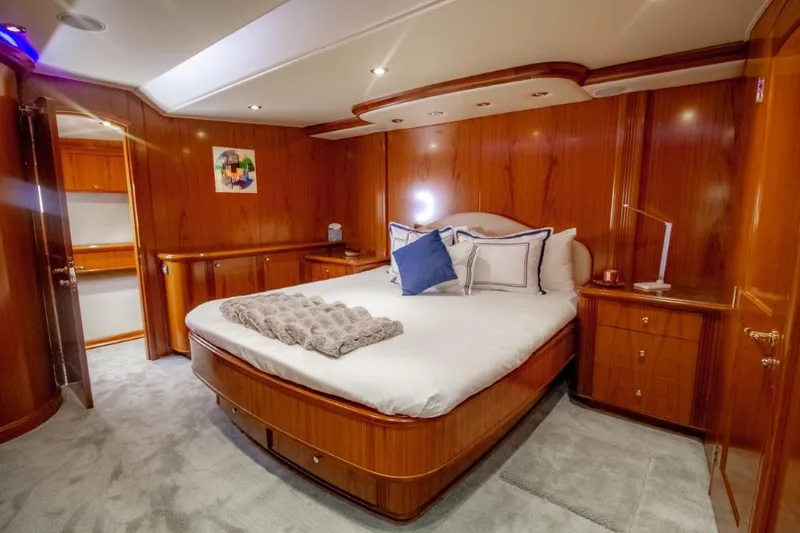 Reel Deal Yacht Photos Pics Luxurious 2005 Sea Force Sportfish yacht bedroom with elegant wood paneling and plush bedding.