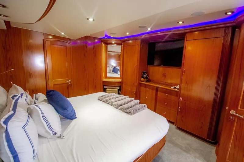 Reel Deal Yacht Photos Pics Luxurious cabin interior of 2005 Sea Force Sportfish yacht with wood paneling and modern amenities.