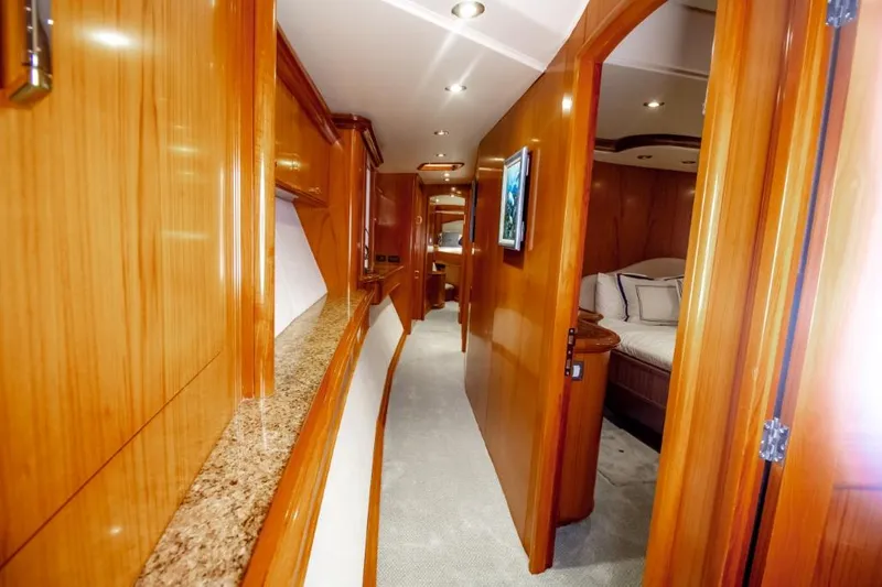 Reel Deal Yacht Photos Pics Luxurious 2005 Sea Force Sportfish yacht interior with wood paneling and cozy bedroom.